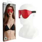 Red sleep mask on a mannequin head with packaging displaying a woman wearing it.